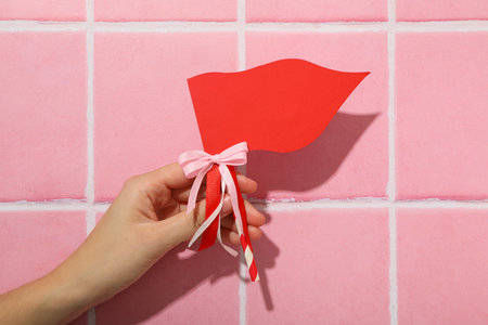 Red flag, accessory for Valentine's Day on a pink background.の写真素材