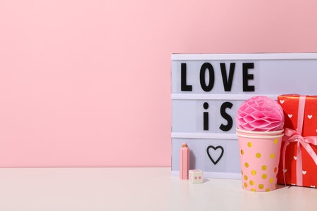 Blackboard with the words "Love is" on a red background.の写真素材