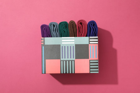 Multicolored high socks on a pink background.