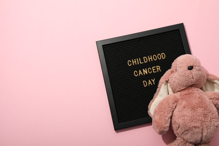 A black board with the inscription Childhood Cancer Day and with a rabbitの写真素材
