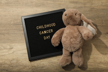 A black board with the inscription Childhood Cancer Day and with a rabbitの写真素材
