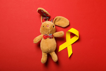 A soft toy bunny with a yellow ribbonの写真素材