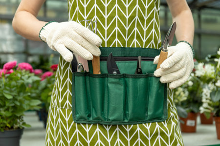 Tools for plant care, for watering, trimming, fluffing. On the waist cover.の写真素材