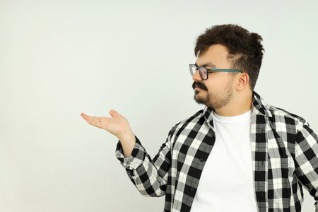 A fat man points to himself, on a gray background.の写真素材