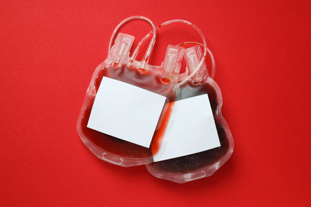 Bags with donor blood on red background, top viewの写真素材