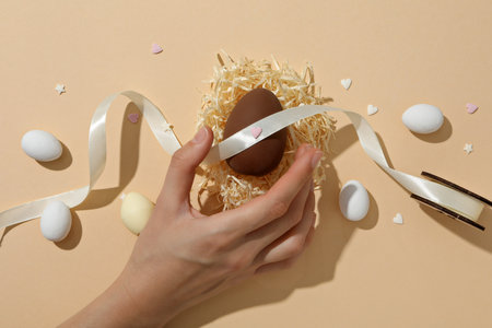 A chocolate egg in a decorative nest