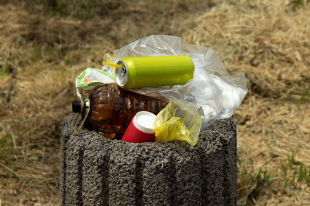 An overflowing garbage can on the street.