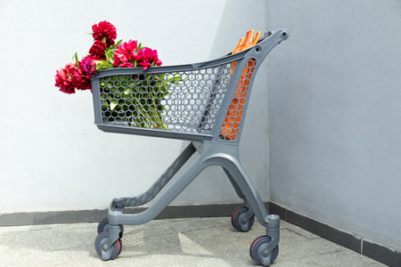Flowers in a shopping cart, outdoors, summer.の写真素材