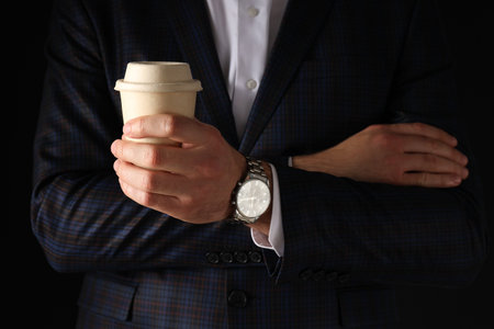 A man in a black suit on a black backgroundの写真素材