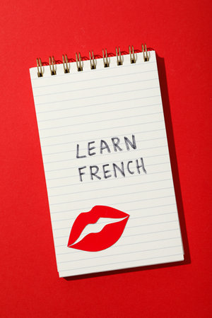 Notepad with the message of learning the French language.の写真素材