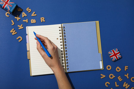 The concept of learning English, a notebook on a blue background.の写真素材