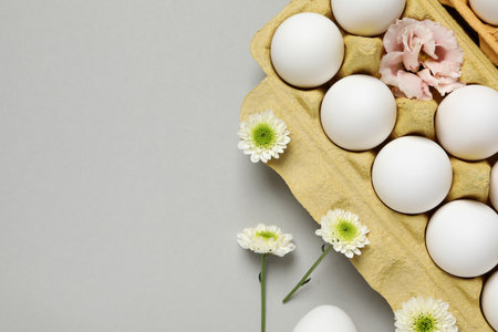 Eggs in a cardboard box with flowers.の写真素材