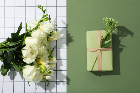A gift with flowers on a green background.の写真素材