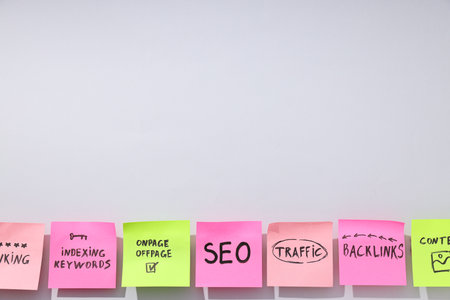 Colored papers with words on white background, space for textの写真素材