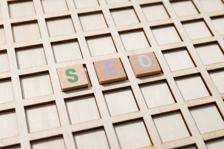 Wooden box with cells and wooden cubes with letters