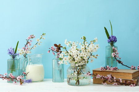 Spring twigs with flowers on a blue background.