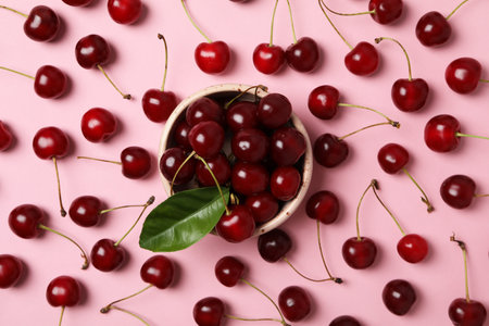 Ripe cherry fruits in a bowl on a pink backgroundの写真素材