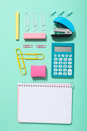 Notebook and stationery on the table, top view.