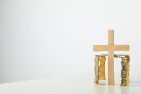 Wooden cross on white background, space for textの写真素材