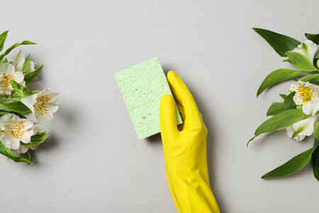 Washcloth and rubber glove with fresh flowersの写真素材