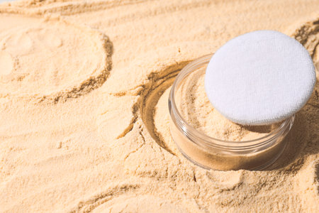 A bottle of light-colored powder on a yellow background.の写真素材