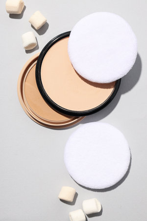 Face powder with marshmallows on a light background.