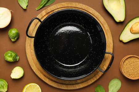A pan for cooking on the table, with ingredients.