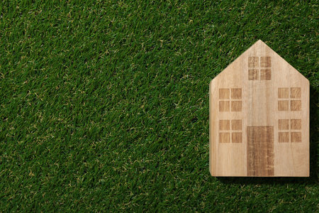 A decorative house on the grass, the concept of an eco houseの写真素材