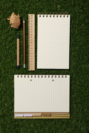 Notebook and stationery on the table, top view.