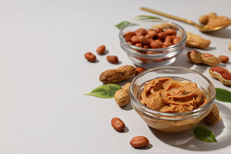 Peanut paste in a transparent plate, on a light background.