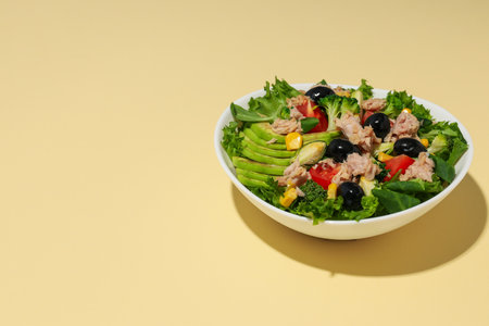 Salad with tuna on a yellow background.の写真素材