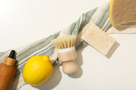 Natural cleaning products, towel, sponge and brush on light background, top viewの写真素材