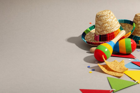 Nachos with sombrero and maracas on a light background