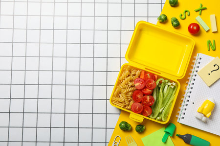 Yellow lunch box with food on a light backgroundの写真素材