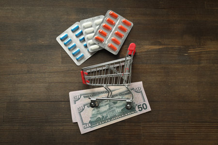 Pills in shopping cart, medical corruption concept.の写真素材