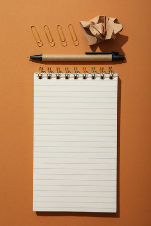 Notebook and stationery on the table, top view.
