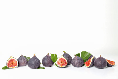 Fresh ripe figs with leaves on a white backgroundの写真素材