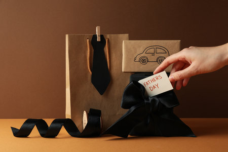 Concept of international father's day, gifts and greetings, on a brown background.