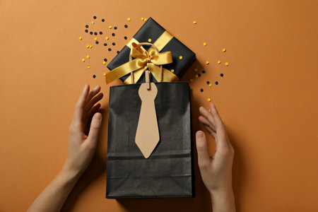A gift for father, for the holiday, on an orange background.
