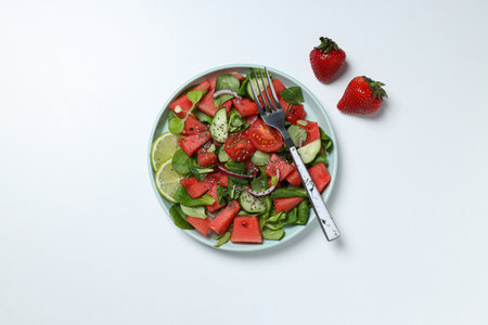 Watermelon salad in a bowl with strawberries and limeの写真素材