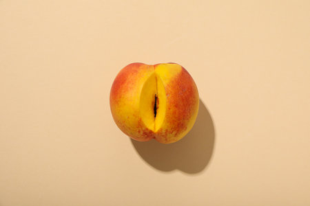 A peach with a cut on a light background.の写真素材