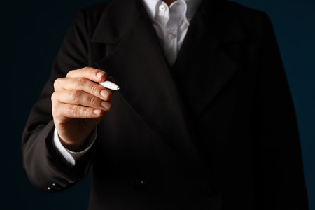 A man in a suit holds a penの写真素材