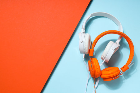 A pair of over-the-ear headphones on a light background.の写真素材
