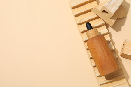 Cosmetic oil in a wooden bottle with a brickの写真素材
