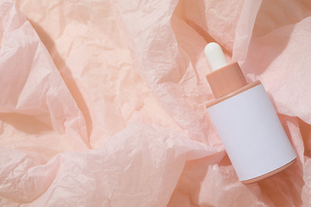 Cosmetic oil in a bottle on a pink backgroundの写真素材