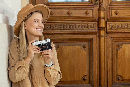 A beautiful girl with a camera on the street.の写真素材
