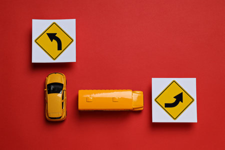 Traffic rules and motor vehicles on a red background.の写真素材