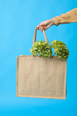 A bag with flowers on a blue backgroundの写真素材