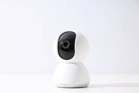 White surveillance camera on a light background
