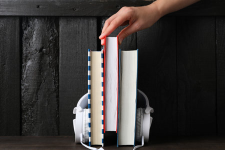 Books with modern headphones, on a dark background.の写真素材